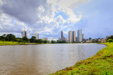 Partial view of the lake in the Parque das Nações Indígenas and buildings in the background, in the city of Campo Grande, capital of Mato Grosso do Sul, Brazil. City in the middle of nature