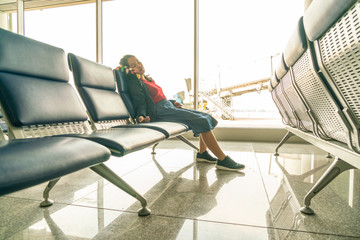 Tired woman waiting and sleeping at the airport terminal