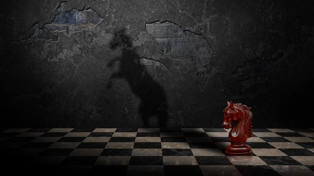 Chess Knight Delusions of Grandeur 4K Loop features a knight chess piece on a board with a concrete wall in the back with the animated shadow of a real horse rearing up on it’s hind legs.