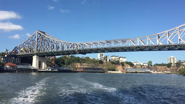 Ferry boats sail under The Story Bridge.It's the longest cantilever bridge in Australia, spanning the Brisbane River in Brisbane Queensland, Australia.