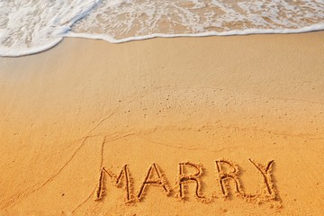 Valentine's day concept, marry writing on sand beach.