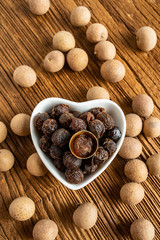 Dried longan and flesh on wooden table