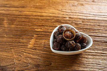 Dried longan and flesh on wooden table