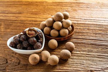 Dried longan and flesh on wooden table