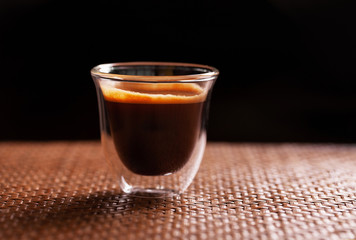 Cup of espresso coffee on wooden background.