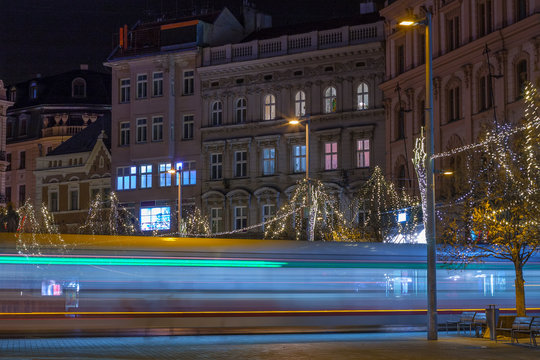 Light trails of tram at Liberty Square in Brno, christmas decoration on tree.