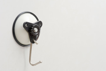 plastic wall hook for cloth with suction cup sticking on white background