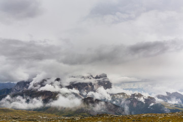 Beautiful scenery in the Dolomite Alps, with rain clouds, mist, and limestone peaks