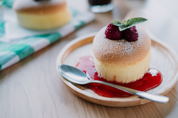 Wooden desk with Japanese cheesecake and cup of coffee in morning, Close up.