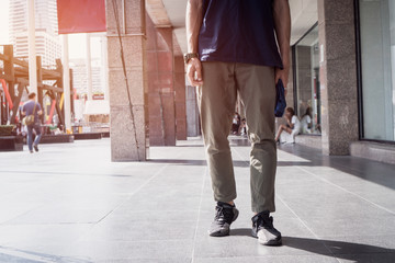 Obraz premium Young Man Asian traveler walking at department store on vacation exploring Bangkok Thailand city. Travel holiday lifestyle concept.