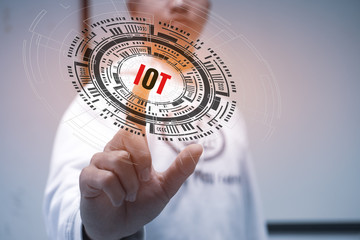Internet of things / IOT concept. Businessman touching presented symbol connected icons iot over technology digital HUD screen background for learning study simulation Futuristic innovation.