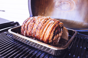 Roasted Pork with crackling skin in an oven roasting tin