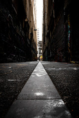 Abstract style photograph looking down a graffiti lined alley way