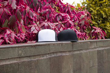 Trucker hat and snapback cap flat visor with black white color in outdoor, ready for your mock up...