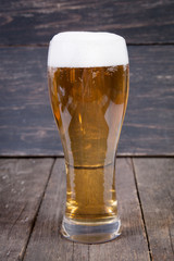 lager draft beer in a glass on dark wooden table