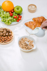 Light healthy Breakfast with oatmeal. Hercules, nuts, fruit, boiled eggs, bread. Tableware. Healthy food.