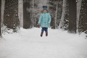 Fototapeta na wymiar cute child girl in winter in the forest