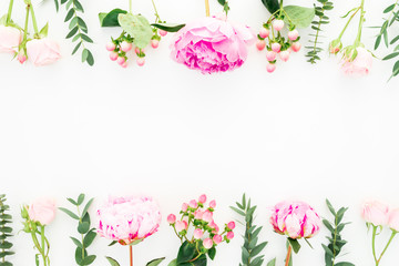 Floral frame of pink peonies, roses, hypericum and eucalyptus on white background. Flat lay, top view