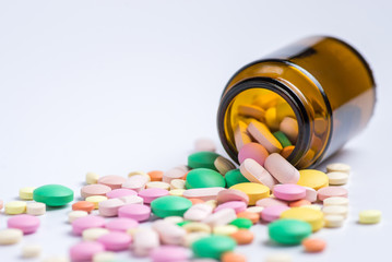 Tablets  in the glass bottle on a white background