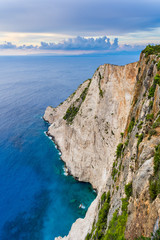 Fototapeta premium Greece, Zakynthos, Abrupt massive rock wall cliff in azure waters at navagio beach