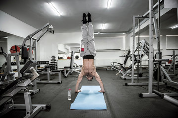 Fototapeta na wymiar Athletic man doing different exercises in gym