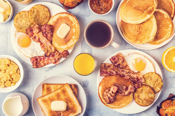 Healthy Full American Breakfast with Eggs Bacon Pancakes and Latkes.
