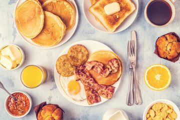 Fototapeta na wymiar Healthy Full American Breakfast with Eggs Bacon Pancakes and Latkes.