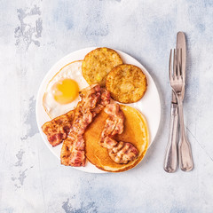 Healthy Full American Breakfast with Eggs Bacon Pancakes and Latkes.