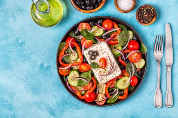 Greek salad of fresh cucumber, tomato, sweet pepper, spinach, red onion, feta cheese and olives