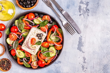 Greek salad of fresh cucumber, tomato, sweet pepper, spinach, red onion, feta cheese and olives