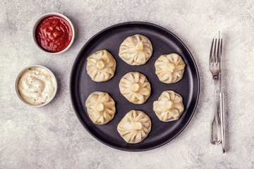 Traditional steamed dumplings Khinkali with Tomato and Tartar sauce