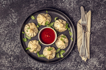Traditional steamed dumplings Khinkali with Tomato and Tartar sauce