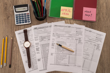 1040 tax form with watch on the table