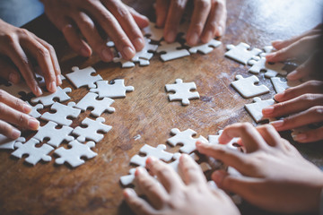Many persons holding pieces of jigsaw puzzle,Teamwork concept,,Business connection,Success and strategy concept,Business accounting