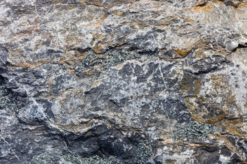 Rough ocean stone texture etched and eroded by ocean waves crashing on it for centuries.