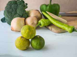Lemon on white wooden table and vegetable background,