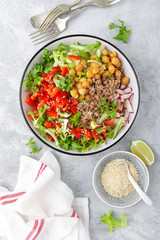 Healthy and delicious bowl with buckwheat and salad of chickpea, fresh pepper and lettuce leaves. Dietary balanced plant-based food. Vegan and vegetarian dish. Top view. Flat lay