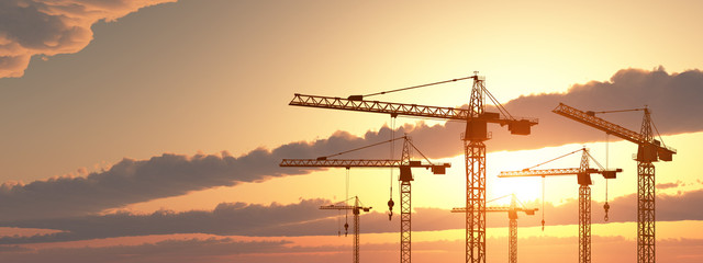 Construction cranes at sunset - 241278866