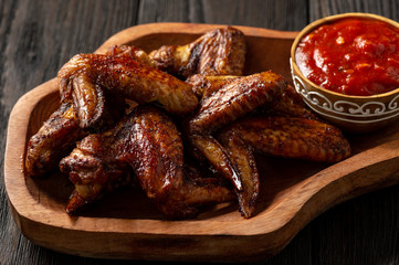 Oven roasted chicken wings with tomato dip.