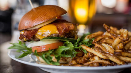 Juicy american hamburger with cheese, grilled ground meat, toppings