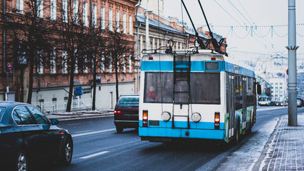 Fototapeta premium trolleybus in the winter city rides on snowy road