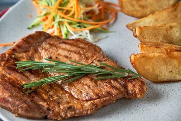 grilled beef steak with vegetables on plate
