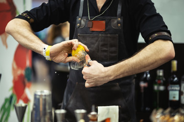 Barmen makes cocktail.