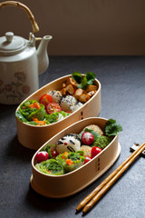 Colorful vegan bento lunch box with green vegetables and tofu