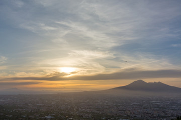 Overview of Naples and its Vesuvius while someone paragliders
