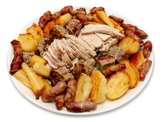 Roast Turkey Dinner With Potatoes Parsnips Sausages and Stuffing