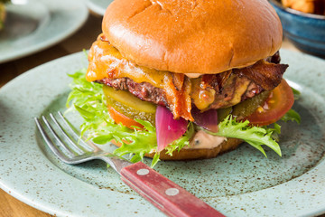 Juicy american hamburger with cheese, grilled ground meat, toppings