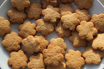 Flower shape biscuit. Golden biscuit over a white background.