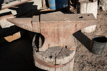 Old rusty iron anvil outdoors