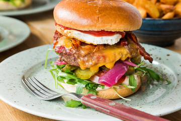 Juicy american hamburger with cheese, grilled ground meat, toppings